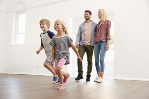 Excited Family Explore New Home On Moving Day